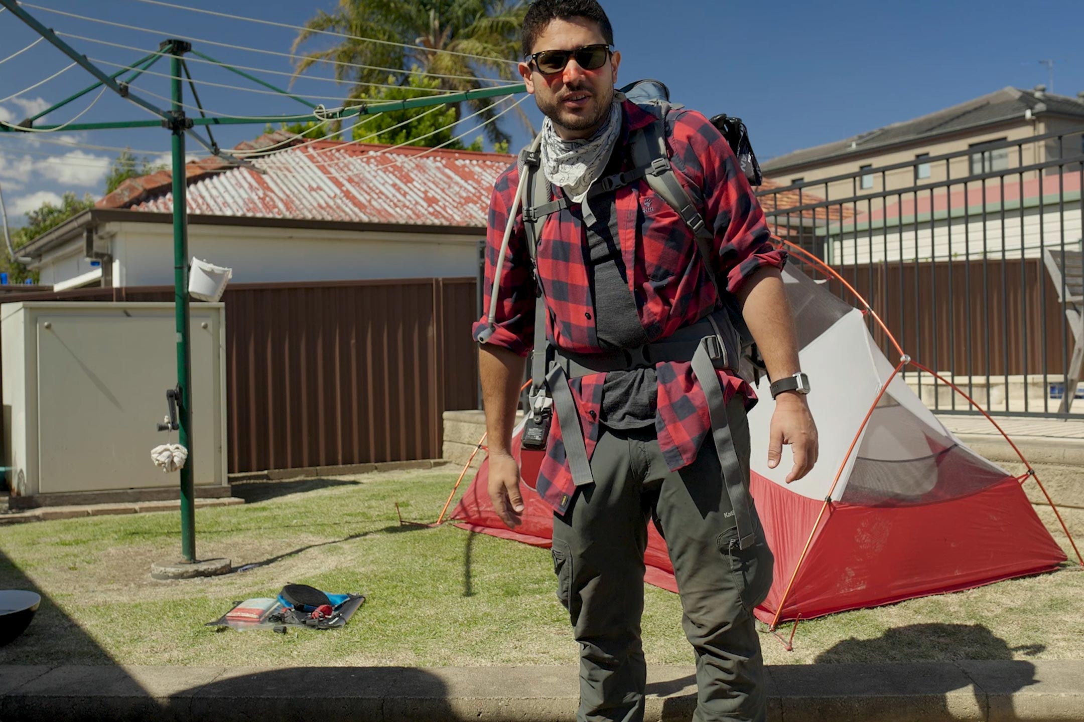 Man in backyard with camping gear